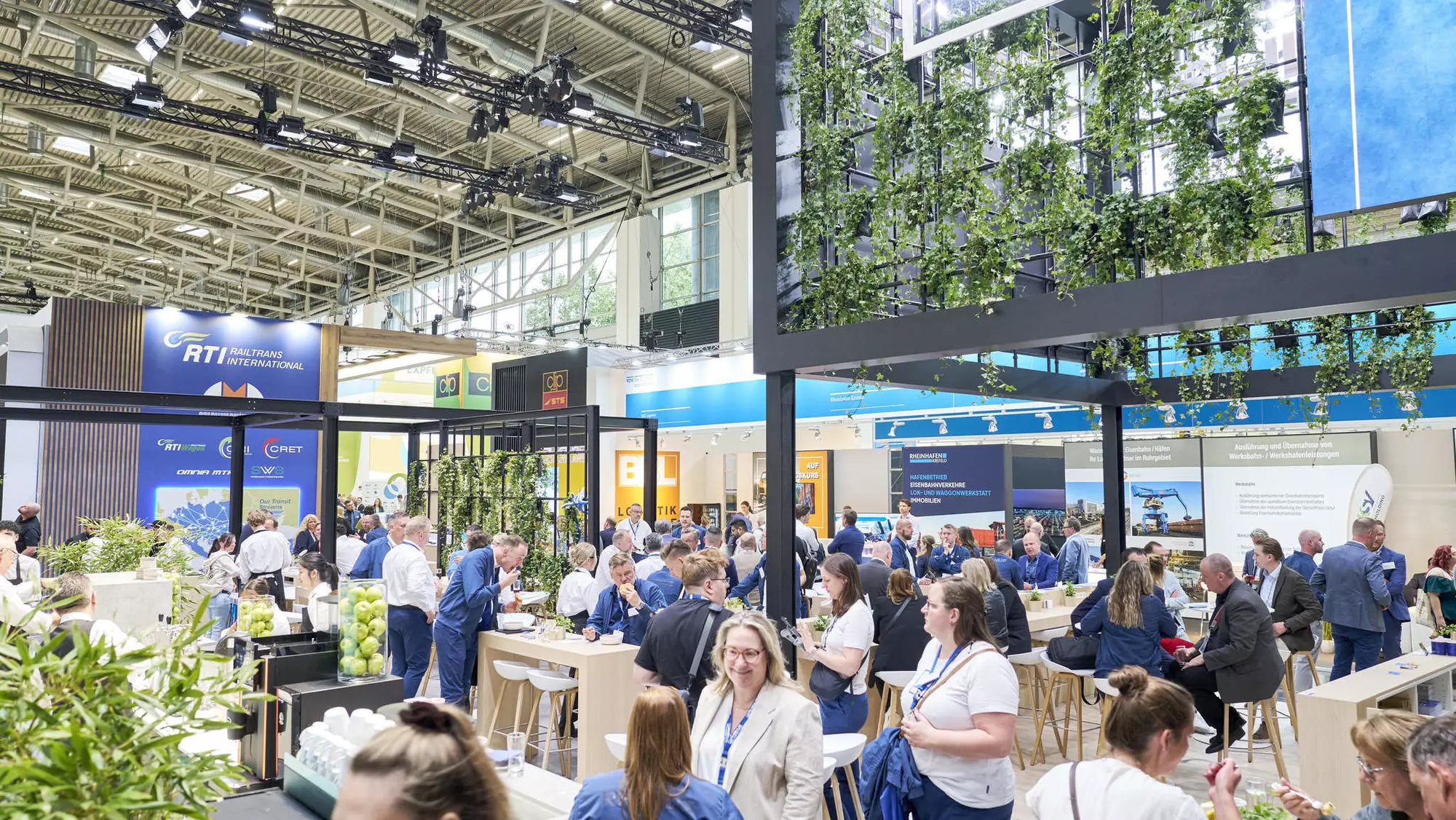 Business meetings taking place at a shared exhibition booth during transport logistic